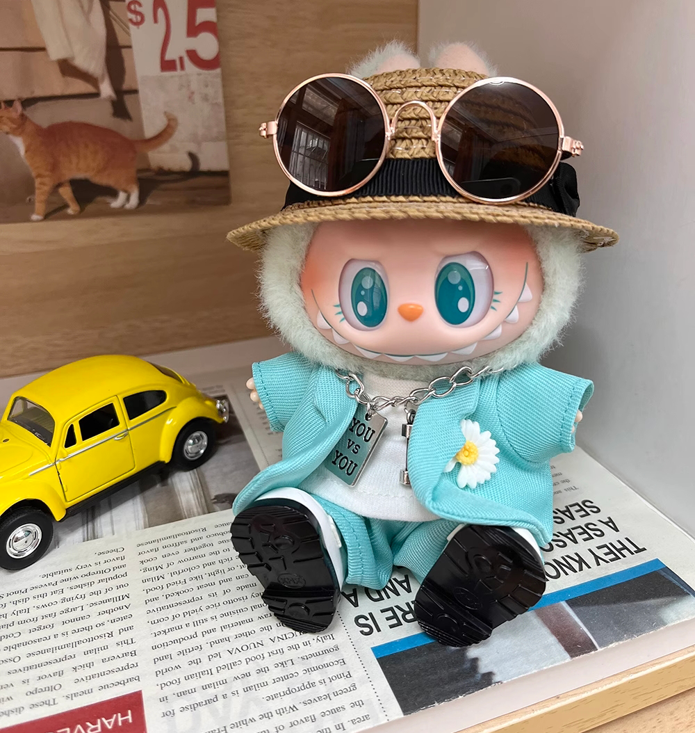 Labubu wearing a handmade G-Dragon inspired outfit – bold K-pop streetwear style with detailed accessories. Custom styles for Exciting Macaron, Big into Energy, and Have a Sit. Blue Mint Outfit. Sitting look.