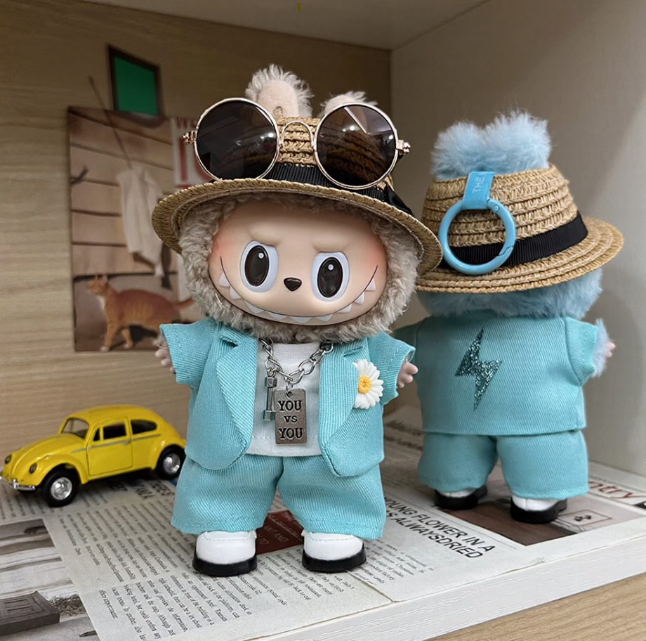 Labubu wearing a handmade G-Dragon inspired outfit – bold K-pop streetwear style with detailed accessories. Custom styles for Exciting Macaron, Big into Energy, and Have a Sit. Blue Mint Outfit. Back view.