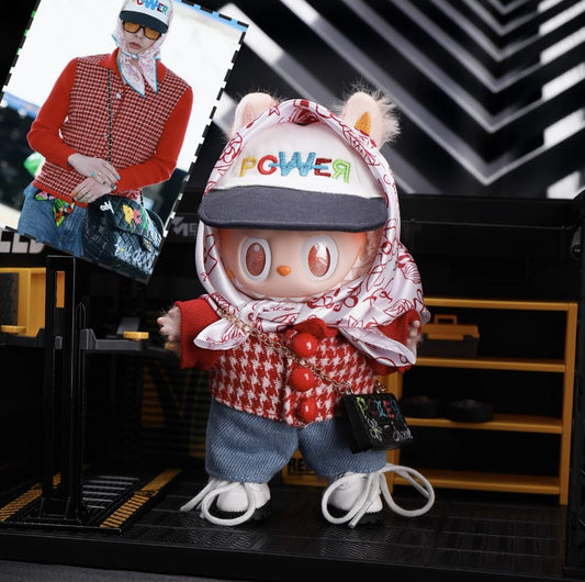 Labubu in a G-Dragon inspired outfit with stylish cap and patterned headscarf – bold K-pop streetwear look. Front view. Photo with G-Dragon on stage.
